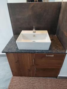 a white sink in a bathroom with a counter at Forestay -3 BHK Villa Kochi in Pallipuram