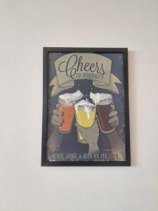 a poster of three people holding glasses of beer at Forestay -3 BHK Villa Kochi in Pallipuram
