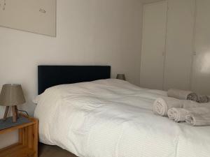 カステッロ・ディ・フィエンメにあるAppartamento Corte del Titoのベッドルーム1室(白いベッド1台、タオル付)