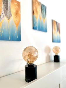 a trophy on a shelf in a room with paintings at M's Residences Maiolica in Trieste