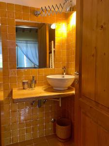 a bathroom with a sink and a mirror at B&B Santa Caterina in Acquaviva Picena