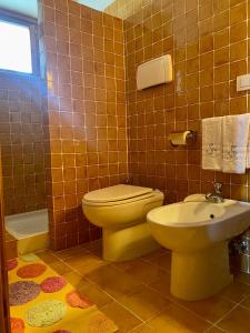a bathroom with a toilet and a sink at B&B Santa Caterina in Acquaviva Picena
