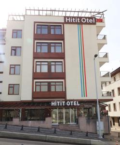 a tall white building with a rainbow on it at HİTİT OTEL in Ankara