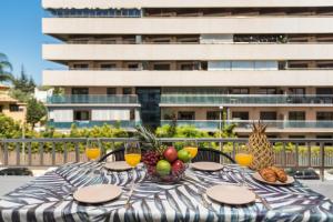 a table with fruit on it with a building in the background at Roy Boston Marbella by Florentia Homes in Marbella