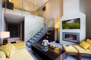 a living room with a couch and a fireplace at BrookLodge & Macreddin Village in Aughrim