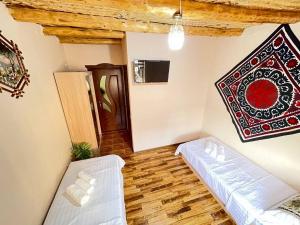 a living room with a couch and a table at Hotel Mohina in Samarkand