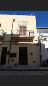 a white building with a balcony and a window at Casa Vacanze Da Laura in San Vito lo Capo