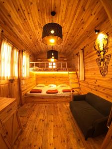 a bedroom with a bed in a wooden cabin at Bombay Camping Company, Pawna Lake Lonavala in Lonavala +20 photos