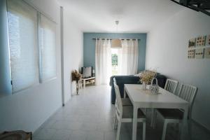 a living room with a table and a dining room at Meraki Homestay Kanali in Kanali