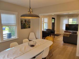 a dining room and living room with a table and chairs at Sunny remodeled craftsman in Georgetown in Seattle