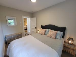 a bedroom with a large white bed with pillows at Sunny remodeled craftsman in Georgetown in Seattle