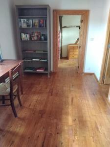 a dining room with a table and a wooden floor at Gîte d'Hildegarde with sauna in Fallais