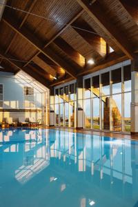 a large swimming pool with blue water in a building at Marine Troon in Troon