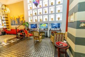 a living room filled with furniture and a tv at CasaBlanca Hotel in San Juan