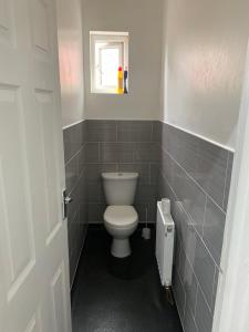 a bathroom with a toilet and a window at The Glebe DN22 in Retford