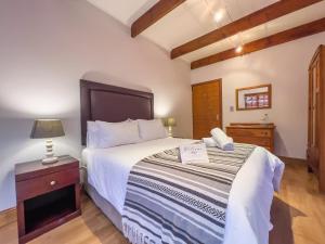 a bedroom with a large bed and a night stand at Tranquility at Its Finest - Kaaimans Luxury Villa in Wilderness +14 photos