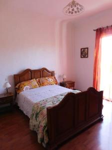 a bedroom with a large bed with a wooden frame at Passerelle Opéra Perpignan in Perpignan