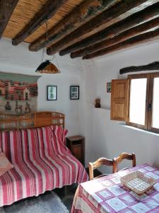 a bedroom with a bed and a table at Cortijo Buena Vista in Laroles