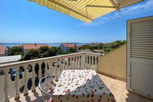 uma mesa numa varanda com vista para o oceano em Apartments by the sea Mandre, Pag - 205 em Kolan