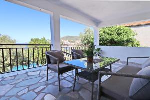 a patio with a table and chairs on a balcony at Apartments by the sea Brna, Korcula - 173 in Smokvica
