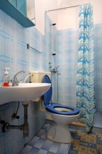 a blue bathroom with a toilet and a sink at Apartments with parking space Lumbarda, Korcula - 179 in Lumbarda