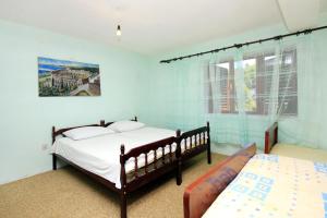 a bedroom with two beds and a window at Apartments with a parking space Prigradica, Korcula - 193 in Blato