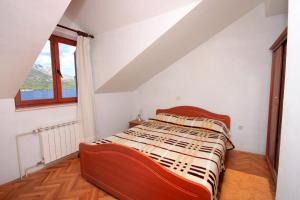 sypialnia z łóżkiem i oknem w obiekcie Apartments by the sea Korcula - 157 w Korčuli