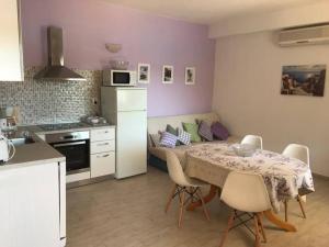 a kitchen with a table and chairs in a room at Apartments by the sea Racisce - Korcula - 151 in Račišće