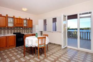 a kitchen with a table and a view of the water at Apartment Prizba 176a in Prizba