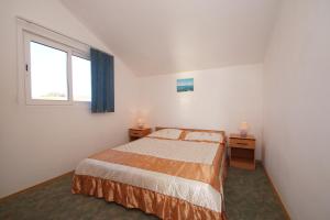 a small bedroom with a bed and a window at Apartments by the sea Zavalatica, Korcula - 247 in Zavalatica