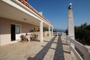 a patio with a table and chairs on a house at Apartments by the sea Zavalatica, Korcula - 247 in Zavalatica