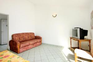 a living room with a couch and a tv at Apartments by the sea Zavalatica, Korcula - 247 in Zavalatica