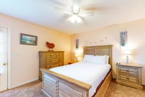 a bedroom with a bed and a ceiling fan at Gulf Highlands - 173 Damon Circle in Panama City Beach