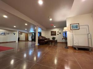 a large living room with a couch and a tv at Americas Best Value Inn and Suites Ada in Ada