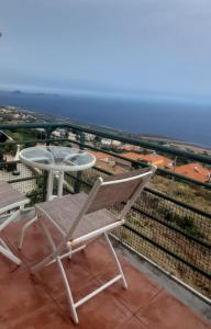 a chair and table on the roof of a building at Jota Paradise in Santa Cruz