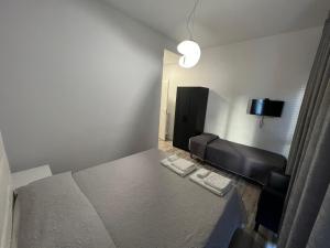 a small room with a bed and a couch at Affittacamere Umberto I in Foligno