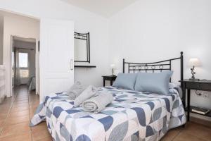 a bedroom with a bed with towels on it at Los Majos Fuerteventura in Tarajalejo
