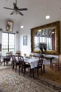 a dining room with a table and a mirror at Gruene River Inn in New Braunfels