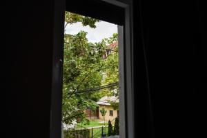 an open door with a view of a house at The White Tree in Prishtinë