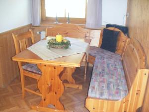 a wooden table with a candle on top of it at Ferienhof Reichart in Scheidegg