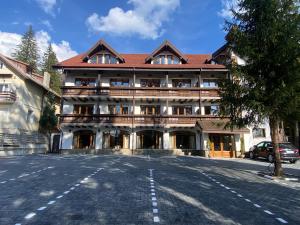 a large building with a balcony on a street at Chalet Wiese in Poiana Brasov