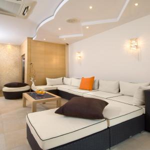 a living room with two white couches and a table at Hotel Muccioli in Misano Adriatico