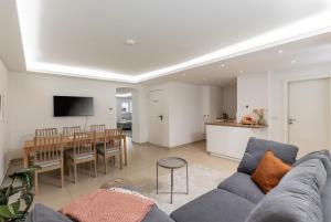a living room with a couch and a dining room at Spacious apartment in Hemholtzkiez Prenzlauer Berg for 8 People in Berlin
