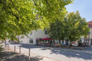 a building with tables and chairs on a street at Apartment im Herzen von Braunschweig mit Parkplatz in Braunschweig