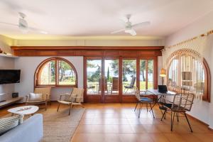 a living room with a table and chairs at Luna Villa Private Beach in Nea Irakleia