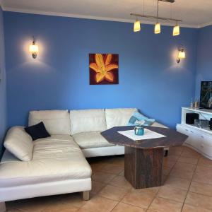 a living room with a white couch and a table at Ferienhaus-Binz in Binz