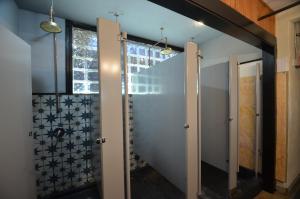 a bathroom with a walk in shower next to a window at Michie Hostel in Providence