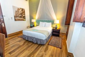 a hotel room with a bed and two lamps at CasaBlanca Hotel in San Juan