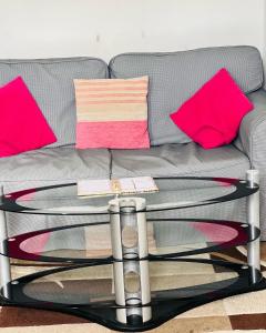 a glass coffee table in front of a couch at SIMPLE 2BED FLAT IN EDINBURGH. in Edinburgh
