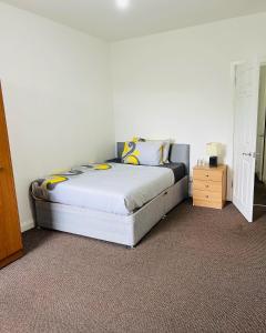 a bedroom with a bed in a white room at SIMPLE 2BED FLAT IN EDINBURGH. in Edinburgh